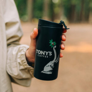 Hand holding a black Tony's x Miir Elephant Tumbler