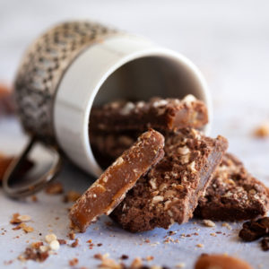 Close up of Sugar Bee Salted Milk Chocolate Toffee spilling out of an espresso cup